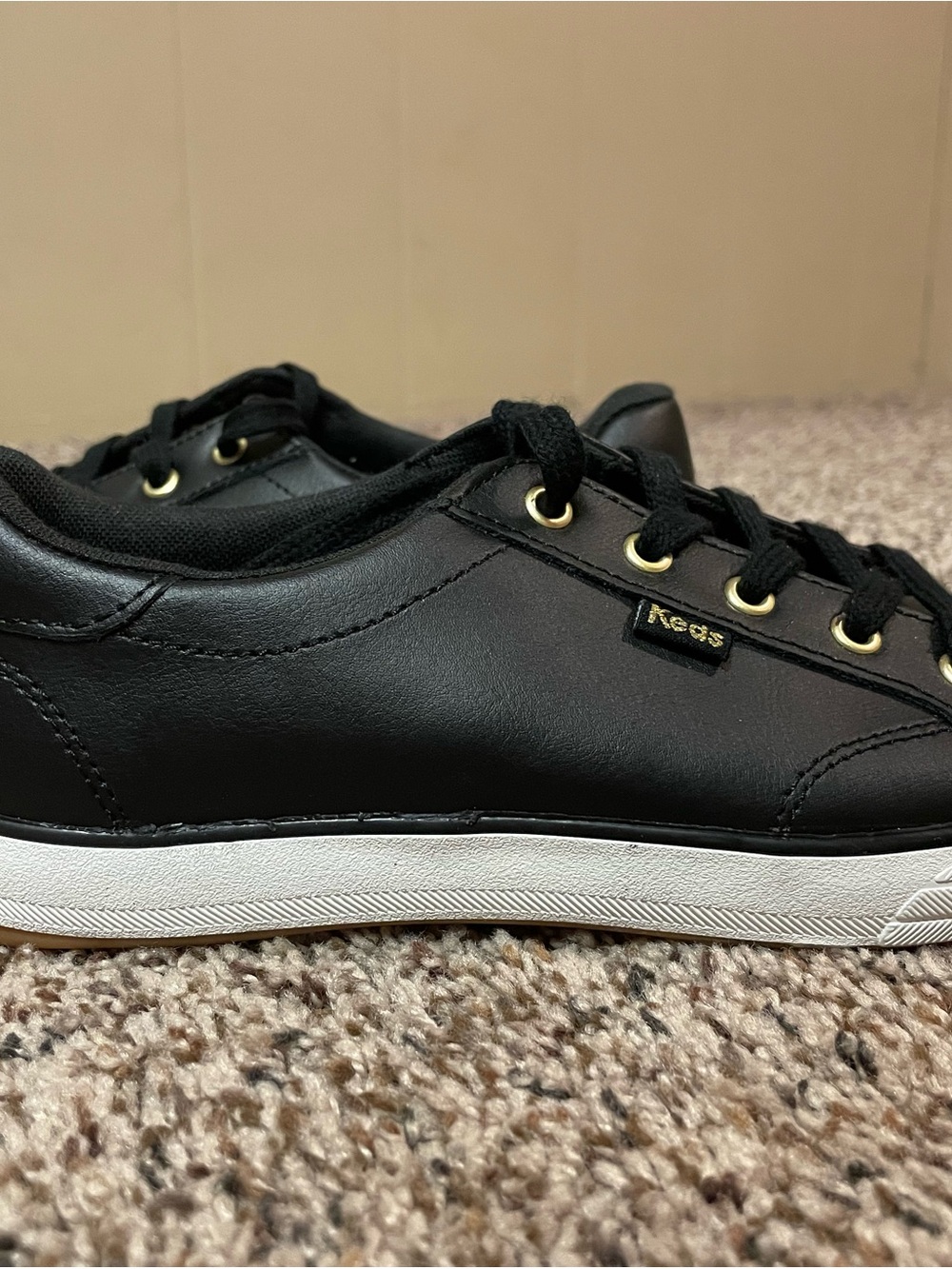 Keds Black Leather Low-Profile Sneakers with White Sole and Gold Accents